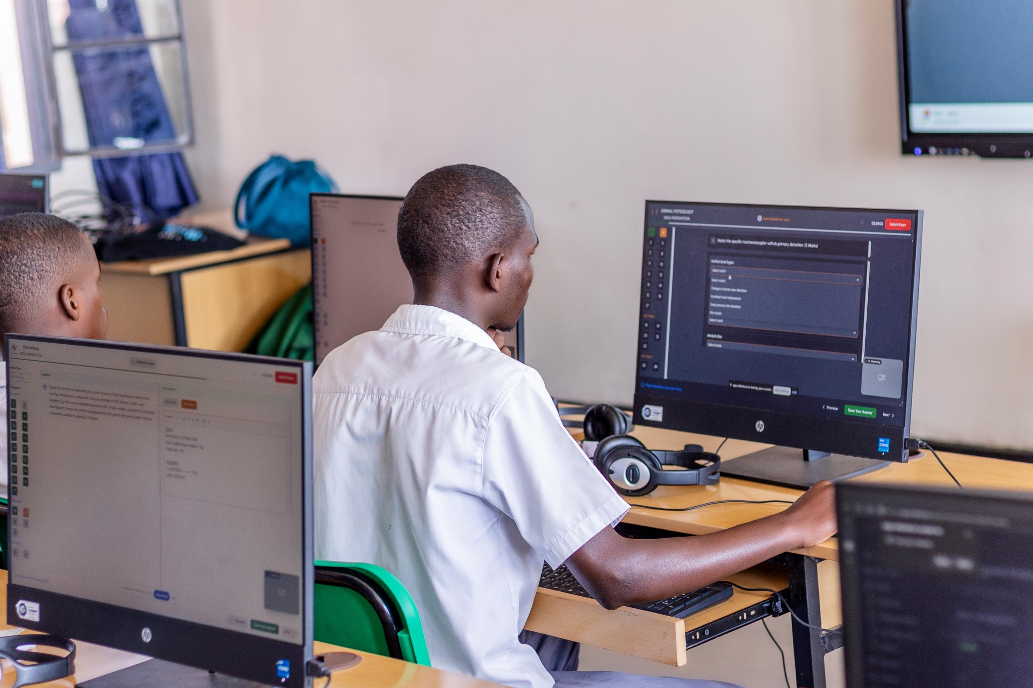 A student in Rwanda working through a course on VIDANTE AI on a laptop